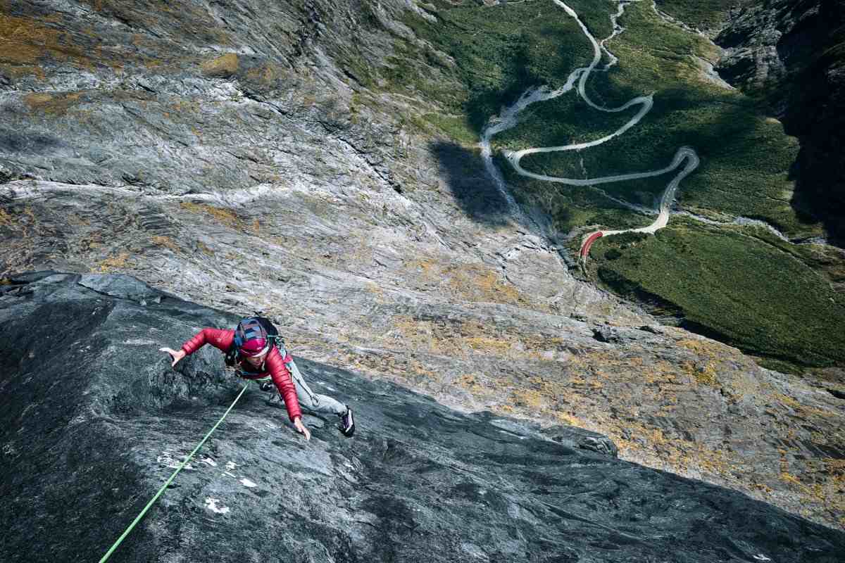 Climber in red jacket and helmet at Lucky Strike in the Darran Mountains