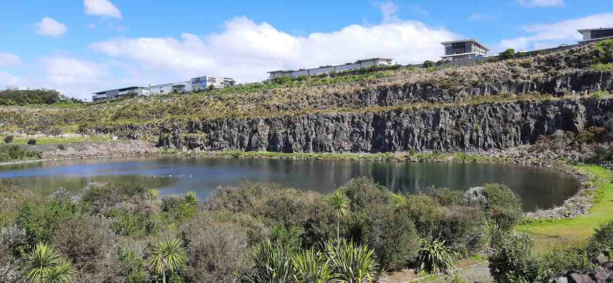 Quarried rock faces next to a lake at Maungarei Springs, Auckland.