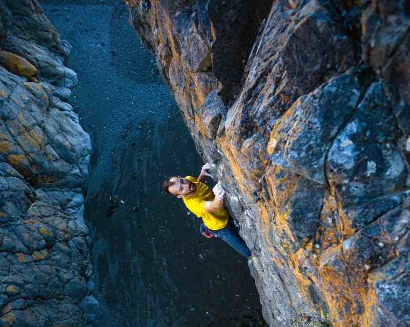 Climber in yellow on a boulder